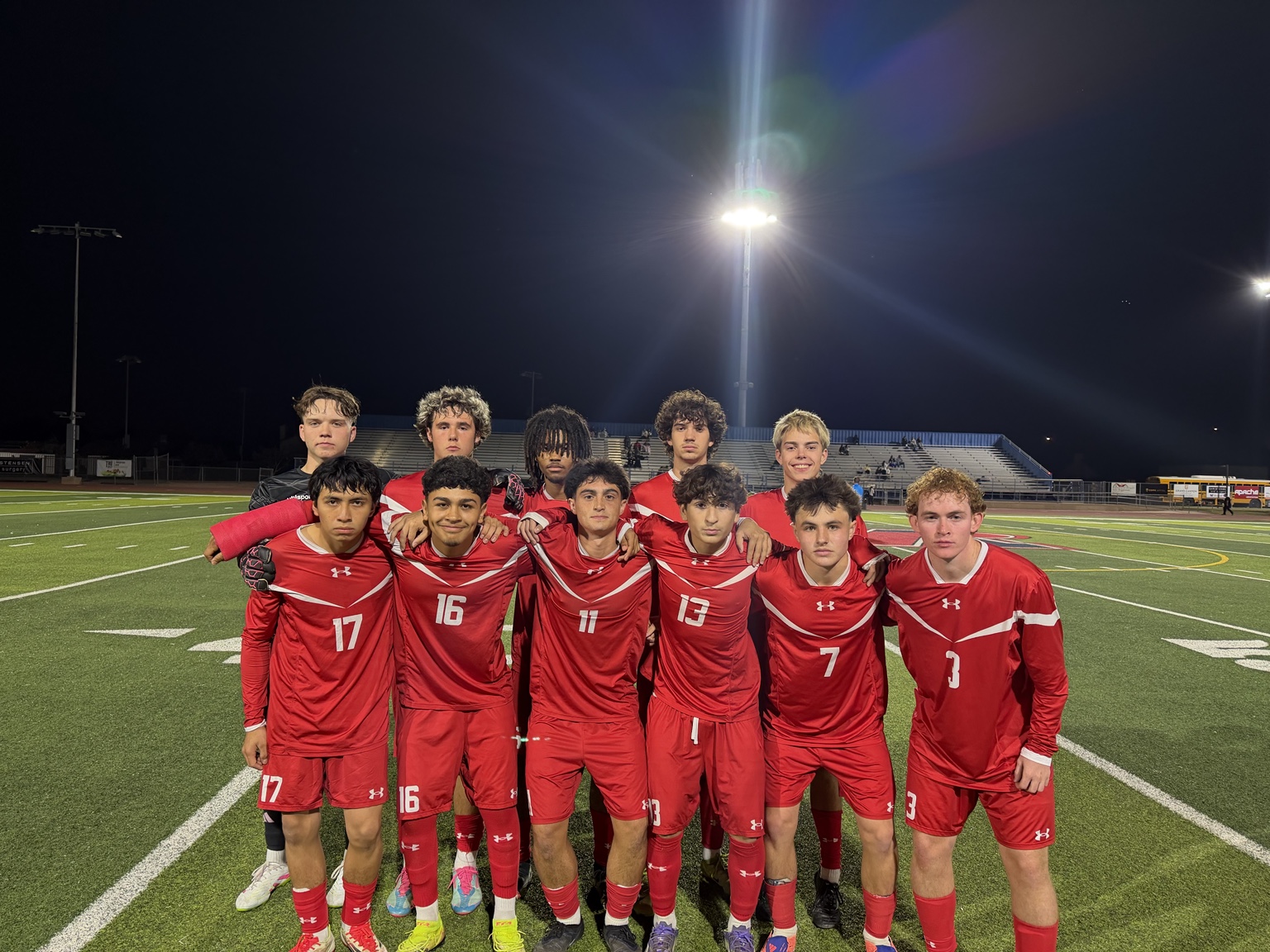 Mountain View boys soccer team together under the stadium lights