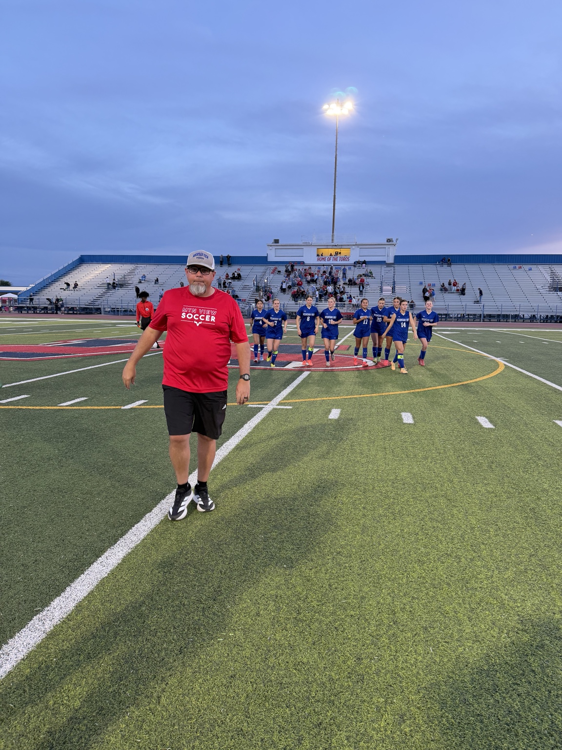 Mountain View girls soccer coach leading the team across the field