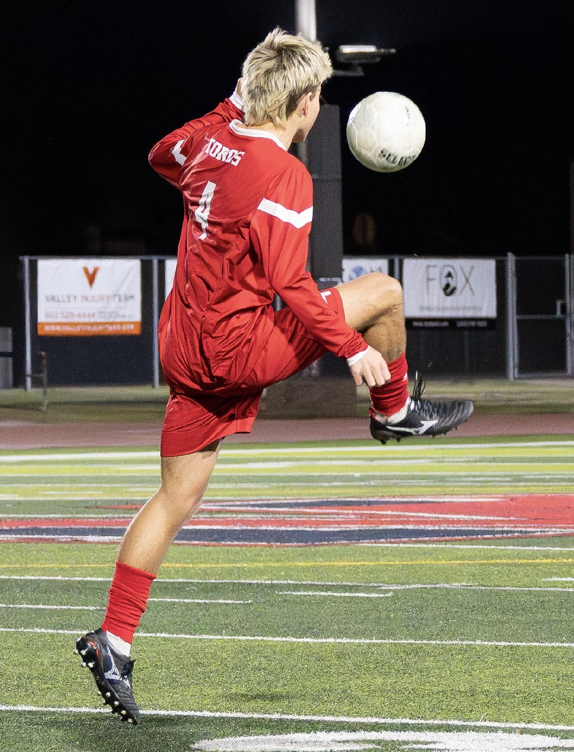 Mountain View boys soccer player controlling the ball under the lights