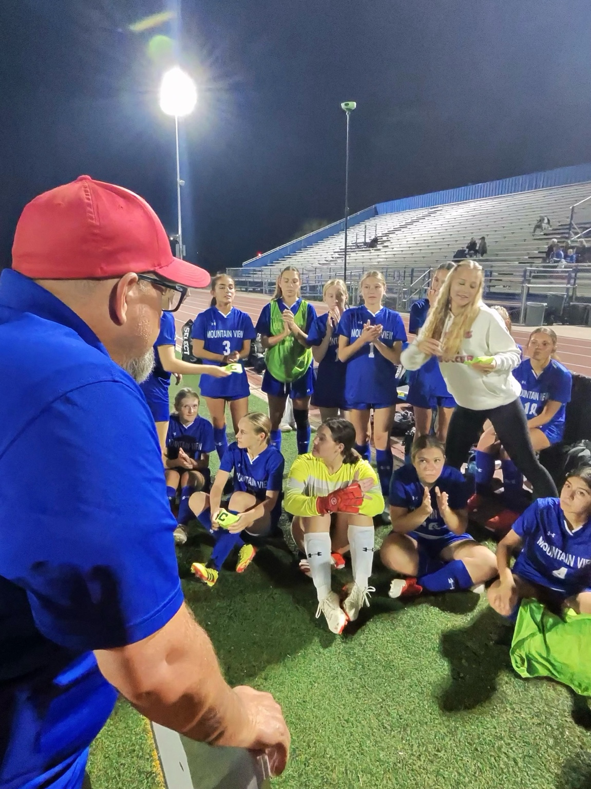 Mountain View girls soccer team gathered with coaches after the match